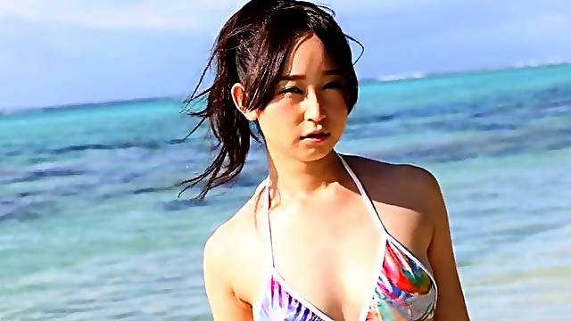 Lovely Asian girl Yumi Ishikawa swims in the ocean
