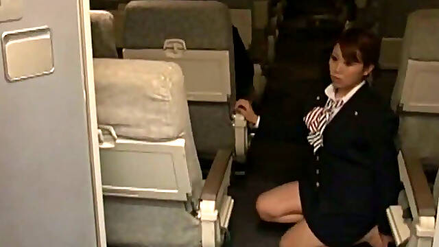 Sexy stewardess is stroking my dick with her hand on a plane