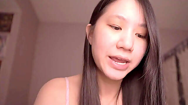 Asian solo girl studies bible while playing with her hair