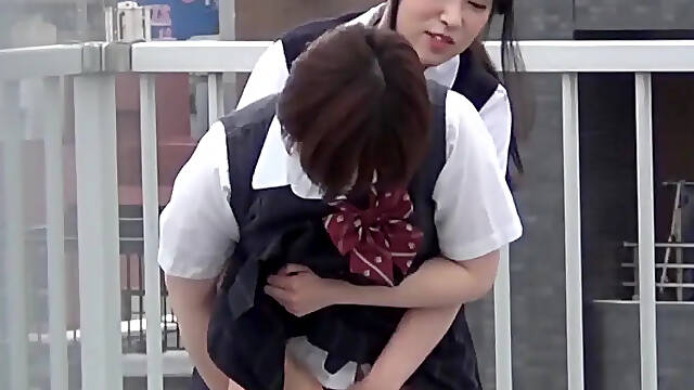 Asian schoolgirls pee together in secluded rooftop setting
